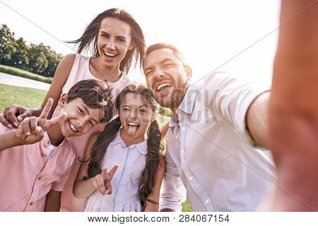 Beautiful Memories. Family Of Four Taking Selfie Photo On Smartp