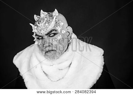 Demon On Black Background, Close Up. Man With Thorns Or Warts In Fur Coat. Alien, Demon, Sorcerer Ma