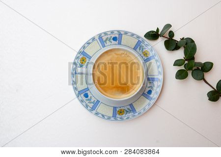 Morning Composition With A Coffee Cup And Branch With Green Leaves