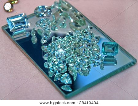 Loose Aquamarine Gemstones On Mirror