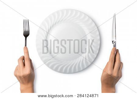 Woman hands holding a silver fork and knife isolated on white