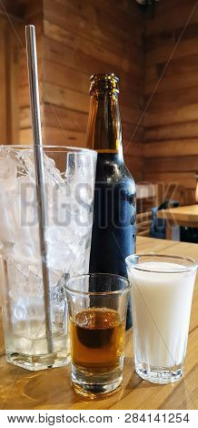 Black Coffee Packed In Glass Bottles With Fresh Milk, Honey And Ice In The Clear Glass,cold Brew Cof
