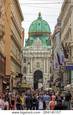 Vienna, Austria - June 27, 2015: Tourists On Kohlmarkt Street With Hofburg Complex In Downtown Of Vi