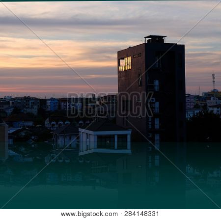 Sunset Of The Metropolitan Rangsit City In Patum Thani ,cityscape Urban Condominium And Reflection O