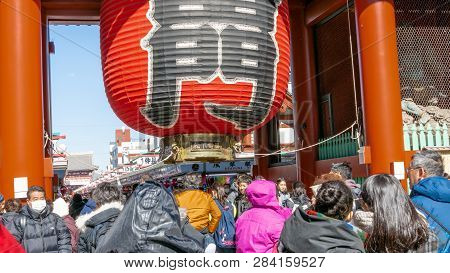 Crowd Of Tourists By Giant Red Lantern In Kaminarimon Gate Of Senso-ji Temple In Asakusa Area. It Is