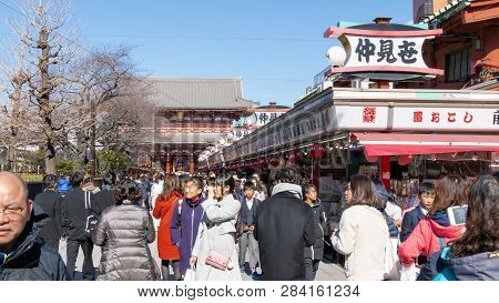 Crowds Of Tourists And Locals Walk And Shop Along Nakamise Dori Shopping Street By Sensoji Shrine In