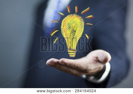Man Hand Light Bulbin  Screen On Table