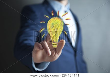 Man Hand Light Bulbin  Screen On Table