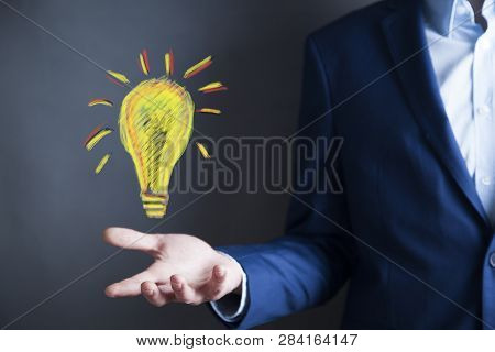 Man Hand Light Bulbin  Screen On Table