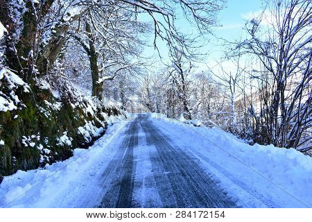 Winter Landscape With Mountain Road And Trees Covered With Snow, Ice And Frost. Blue Sky, Sunny Day.