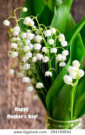 Bouquet Of Lilies Of The Valley On Old Wooden Background.lily Of The Valley Spring Flowers.concept F