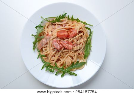 Spaghetti With Schurwald Ham, Sauce And Fresh Argula, Tomatos. Pasta On White Plate.