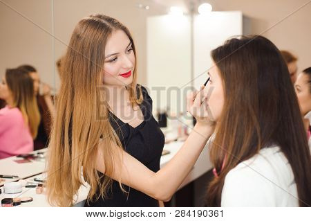Make Up Artist Doing Professional Make Up Of Young Woman.