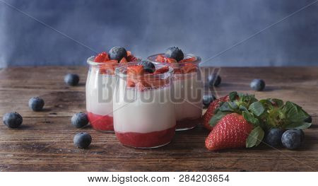 Strawberry Yogurt With Jam And Pieces Of Fruit, On A Wooden Board