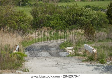 Winding Dirt Road Crossing Culvert At Allens Pond In Dartmouth, Massachusetts