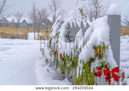 Fence With Garland Against Snowy Landscape In Utah