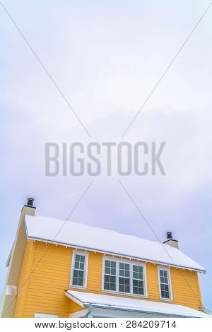 Home With Snowy Roof Against Sky In Daybreak Utah