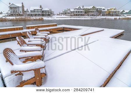 Lake Deck With Chairs Covered With Snow In Winter