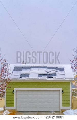 Solar Panels On Snowy Garage Roof In Daybreak Utah
