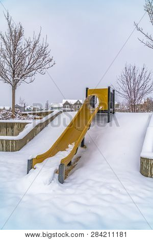 Yellow Slide On Snowy Playground In Daybreak Utah