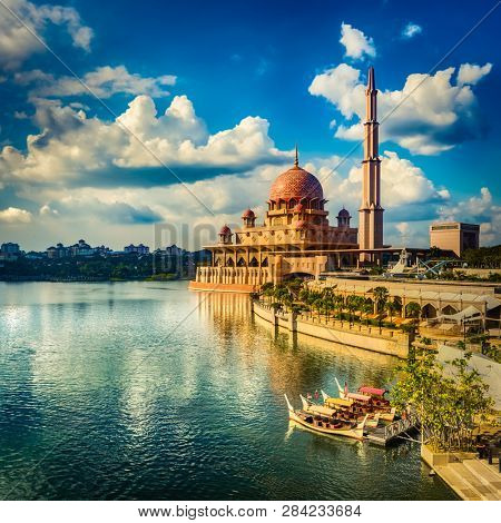  Putrajaya skyline. Boats on the foreground. Amazing view of  Putra mosque at sunset