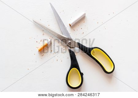 Stop Smoking Cigarettes Concept. Scissors And A Cut Cigarette On A White Background