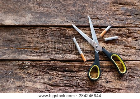 Cigarettes And Scissors On Wooden Background. Stop Smoking Concept