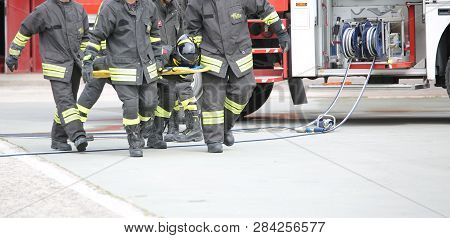 Rome, Rm, Italy - May 10, 2018: Italian Corpsmen Firemen Transport An Injured On The Stretcher Durin