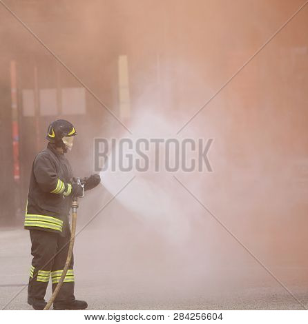 Vicenza, Vi, Italy - May 10, 2018: Italian Firefighter Uses The Hydrant With Foam During A Practice 