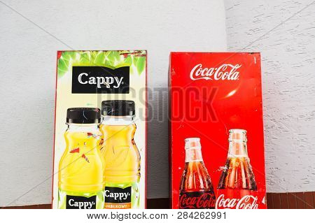 Poznan, Poland - February 7, 2019: Locked Cappy Juice And Coca Cola Vending Machines Against A Wall.