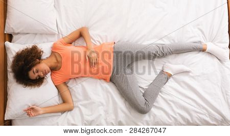 Delighted African-american Woman Having Pleasant Dream, Sleeping In Bed, Top View