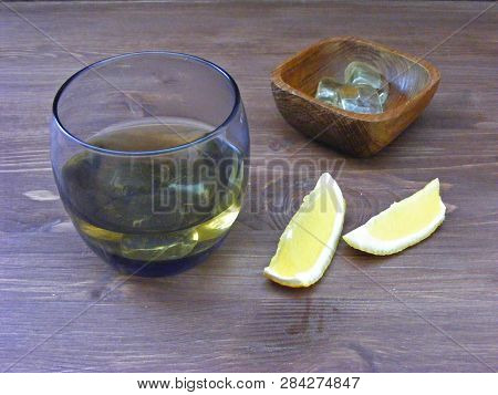 Alcoholic Whiskey Bourbon In A Glass With Ice, Glass Of Cognac With Lemon.