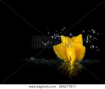Exotic Fruits From Thailand. Star Fruit Falling Into The Water