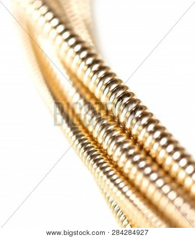 Strings For Guitar Isolated On A White Background. Macro