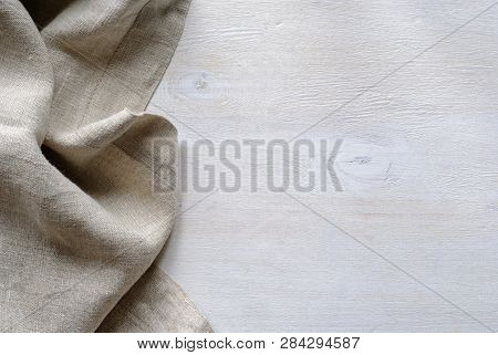 Folded Gathered Border Of A Natural Linen Fabric Showing The Detail Of The Weave Over Textured Paint