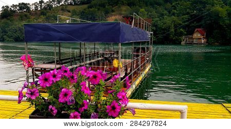 Tourist Raft On The Lake With Flowers