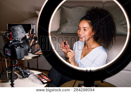 Smiling Beauty Vlogger Recording Video For Her Channel Using Ring Light And Digital Camera