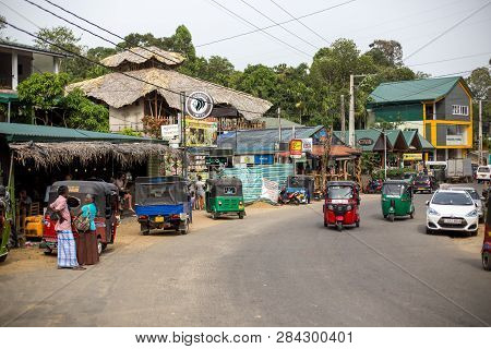 Ella, Sri Lanka - August 3, 2018: Shops, People And Tuk Tuks On The Main Road. Ella Is A Mountain To