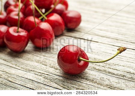 Fresh Red Cherries On Wooden Table Close Up