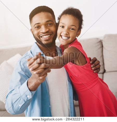 Father And Cute Daughter Dancing At Home And Looking At Camera, Crop