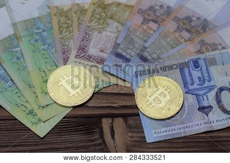Cryptocurrency, Bitcoins, Paper Of The Belarusian Ruble. Metal Coins Are Laid Out On A Flat Backgrou