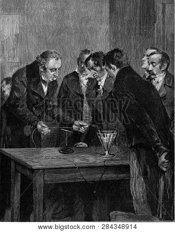 Oersted demonstrates the deviation of the magnetic needle by the electric current, vintage engraved illustration. From the Universe and Humanity, 1910.