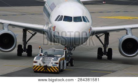 Dusseldorf, Germany - July 23, 2017: Towing Tractor Pushing Germanwings Airbus A319 Jet Airplane On 
