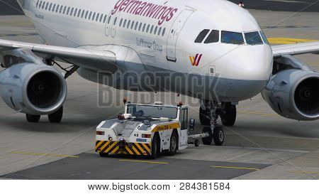 Dusseldorf, Germany - July 23, 2017: Close-up Of Towing Tractor Pushing Germanwings Airbus A319 Jet 