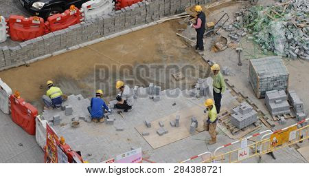 Hong Kong, -28 January 2019: Worker pave the road
