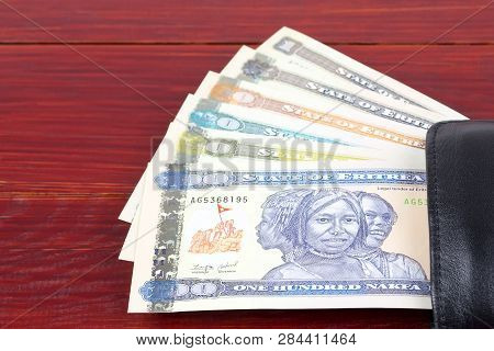 Eritrean Nakfa In The Black Wallet On A Wooden Background