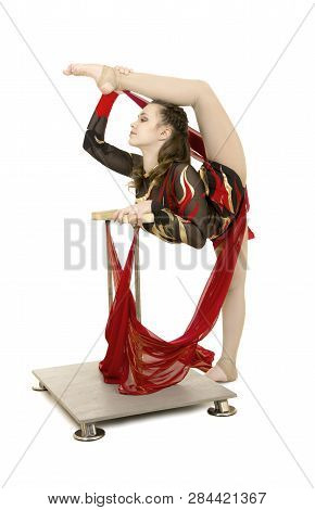 Flexible Equilibrist Performs Exercises On Acrobatic Walking Sticks.
