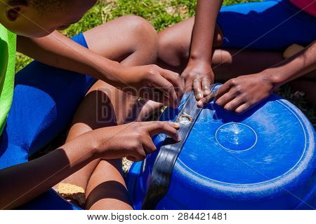 African Children Fixing A Puncture On A Bike