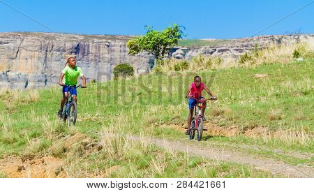 African Children Riding A Bike In Rural A Village