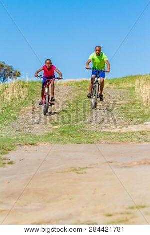 African Children Riding A Bike In Rural A Village